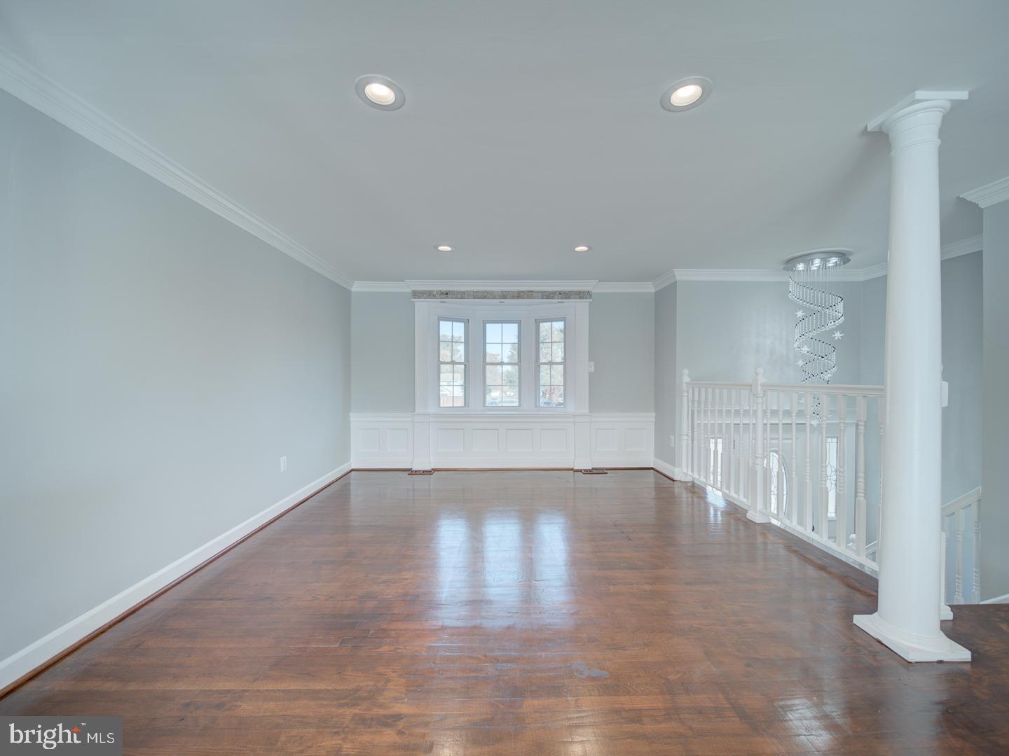 1300 East Beech Road Sterling, VA 20164 - Photo 3 of 35 a view of an empty room with wooden floor and a window