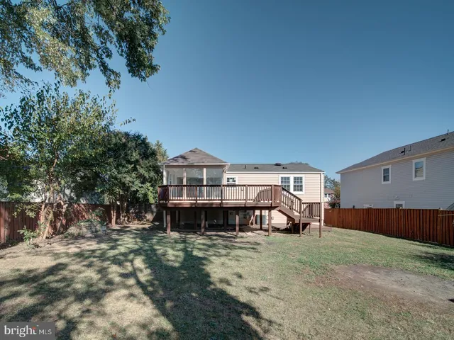 a view of a house with a yard and sitting area