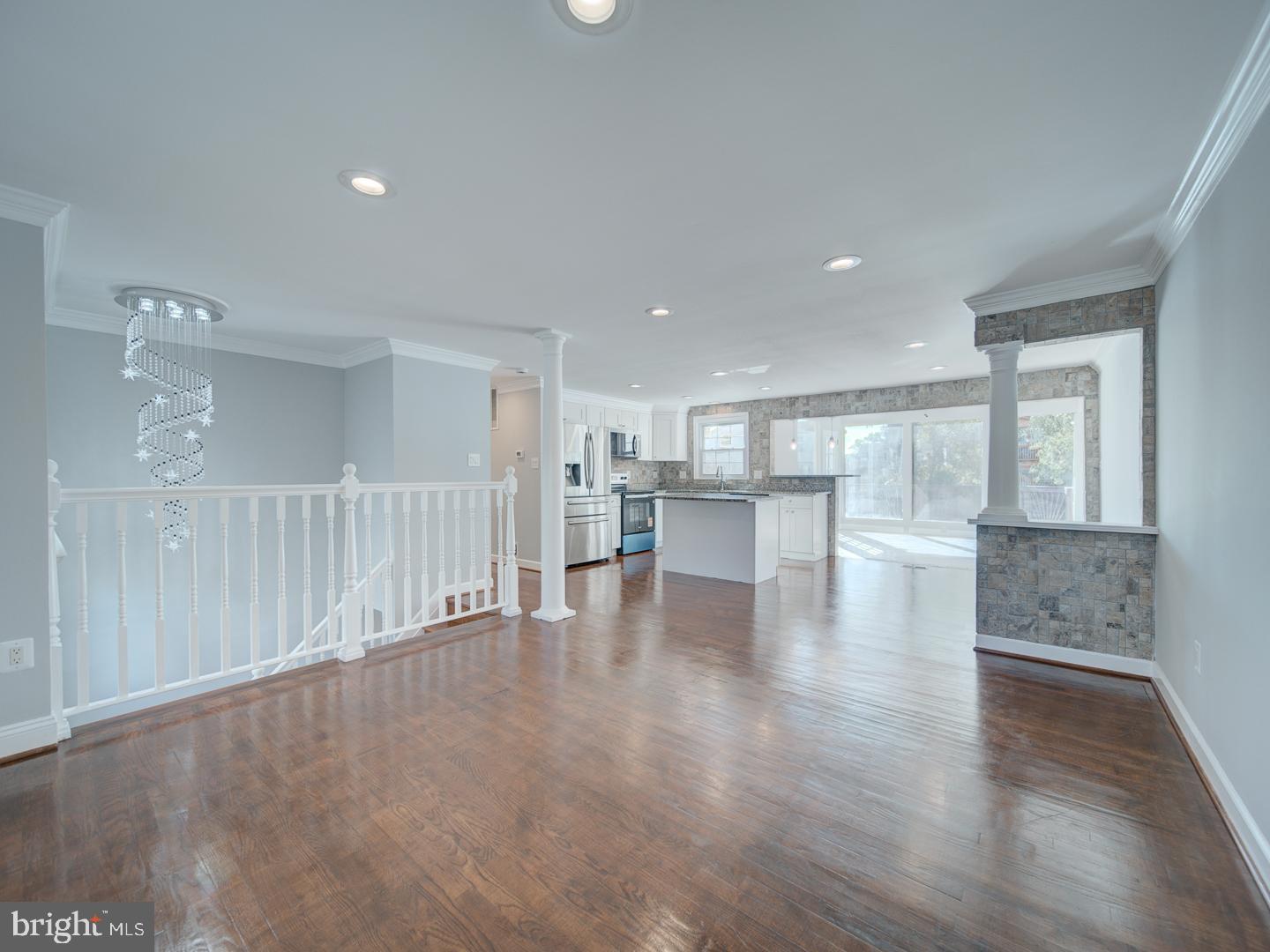 1300 East Beech Road Sterling, VA 20164 - Photo 4 of 35 a view of an empty room with wooden floor and kitchen view
