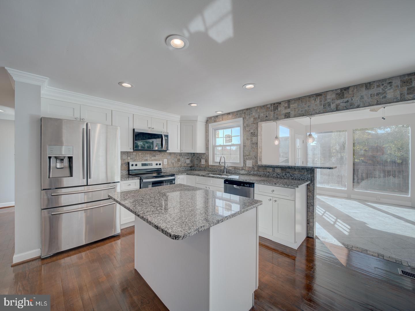 1300 East Beech Road Sterling, VA 20164 - Photo 5 of 35 a kitchen with stainless steel appliances granite countertop a sink stove and refrigerator