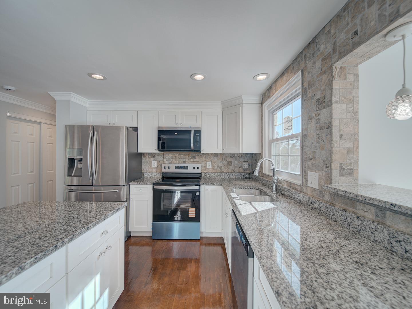 1300 East Beech Road Sterling, VA 20164 - Photo 6 of 35 a large kitchen with a stove sink microwave and refrigerator