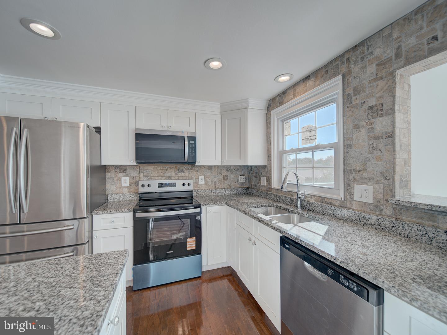 1300 East Beech Road Sterling, VA 20164 - Photo 7 of 35 a kitchen with a sink stove and refrigerator