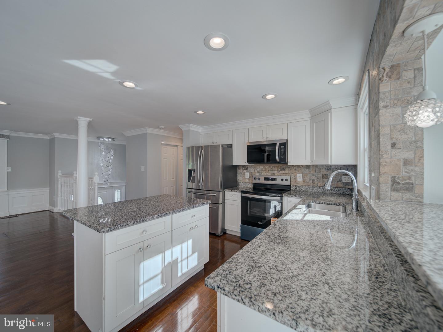 1300 East Beech Road Sterling, VA 20164 - Photo 8 of 35 a large kitchen with stainless steel appliances granite countertop a large counter top and a stove