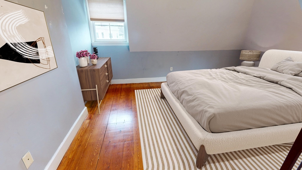 126 Calumet Street, Unit 3 Boston, MA 02120 - Photo 3 of 5 a bed room with a bed and a window