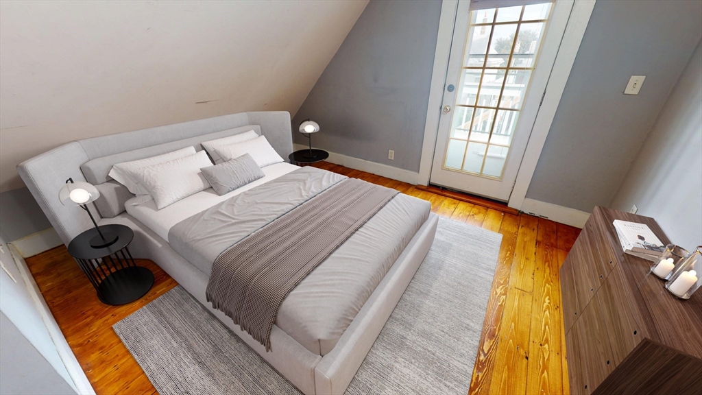 126 Calumet Street, Unit 3 Boston, MA 02120 - Photo 4 of 5 a bedroom with a bed and wooden floor