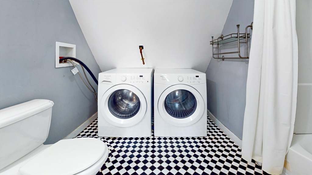 126 Calumet Street, Unit 3 Boston, MA 02120 - Photo 5 of 5 a bathroom with a granite countertop sink and a washing machine