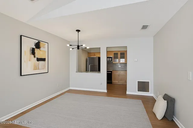 a view of livingroom with hardwood floor and kitchen view