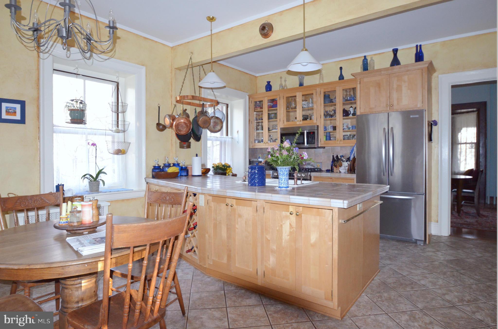 311 Oakdale Road Baltimore, MD 21210 - Photo 15 of 26 a dining hall with stainless steel appliances granite countertop a dining table chairs and a refrigerator
