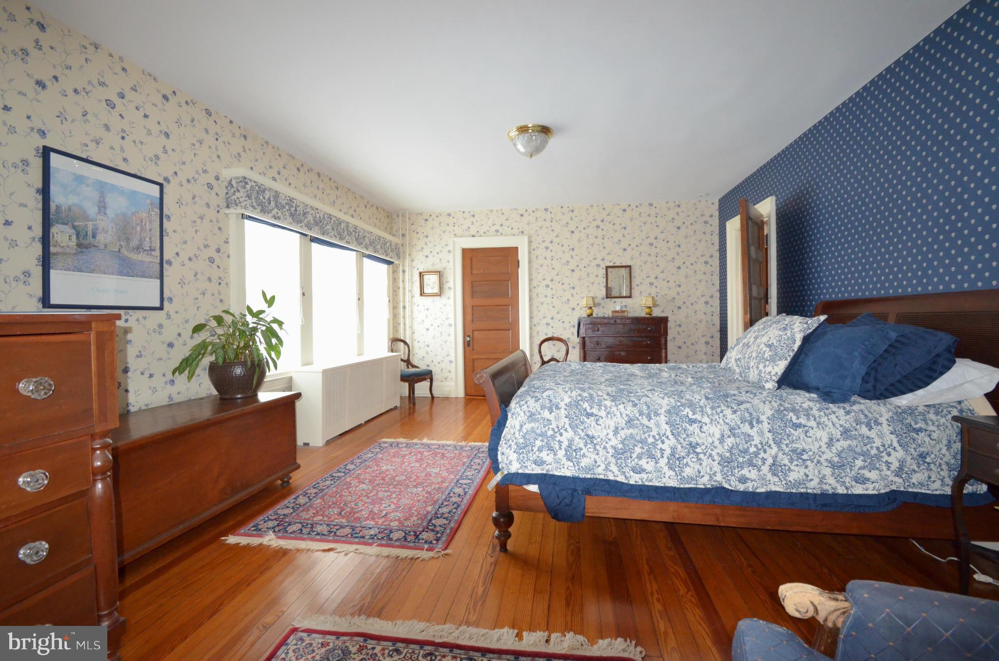 311 Oakdale Road Baltimore, MD 21210 - Photo 19 of 26 a bedroom with a large bed and a dresser