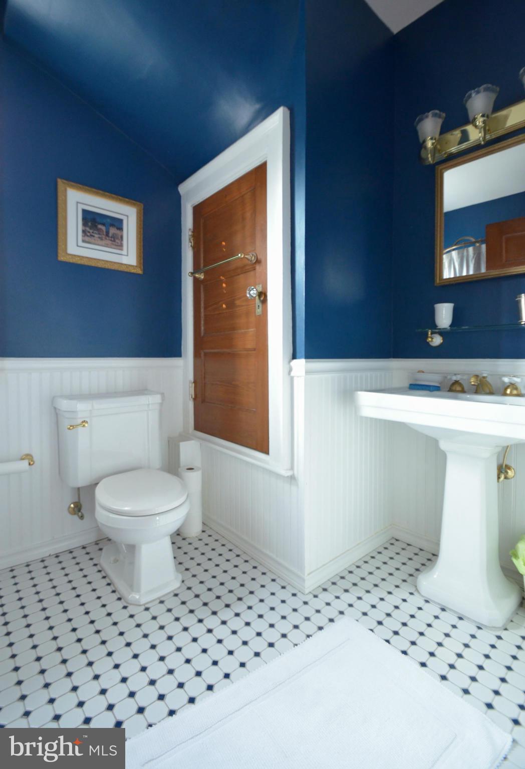 311 Oakdale Road Baltimore, MD 21210 - Photo 23 of 26 a bathroom with a sink a toilet and a mirror