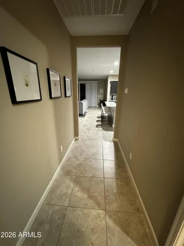 a hallway with a view of living room