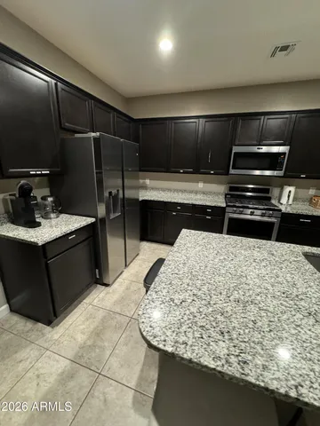 a kitchen with a sink and a refrigerator