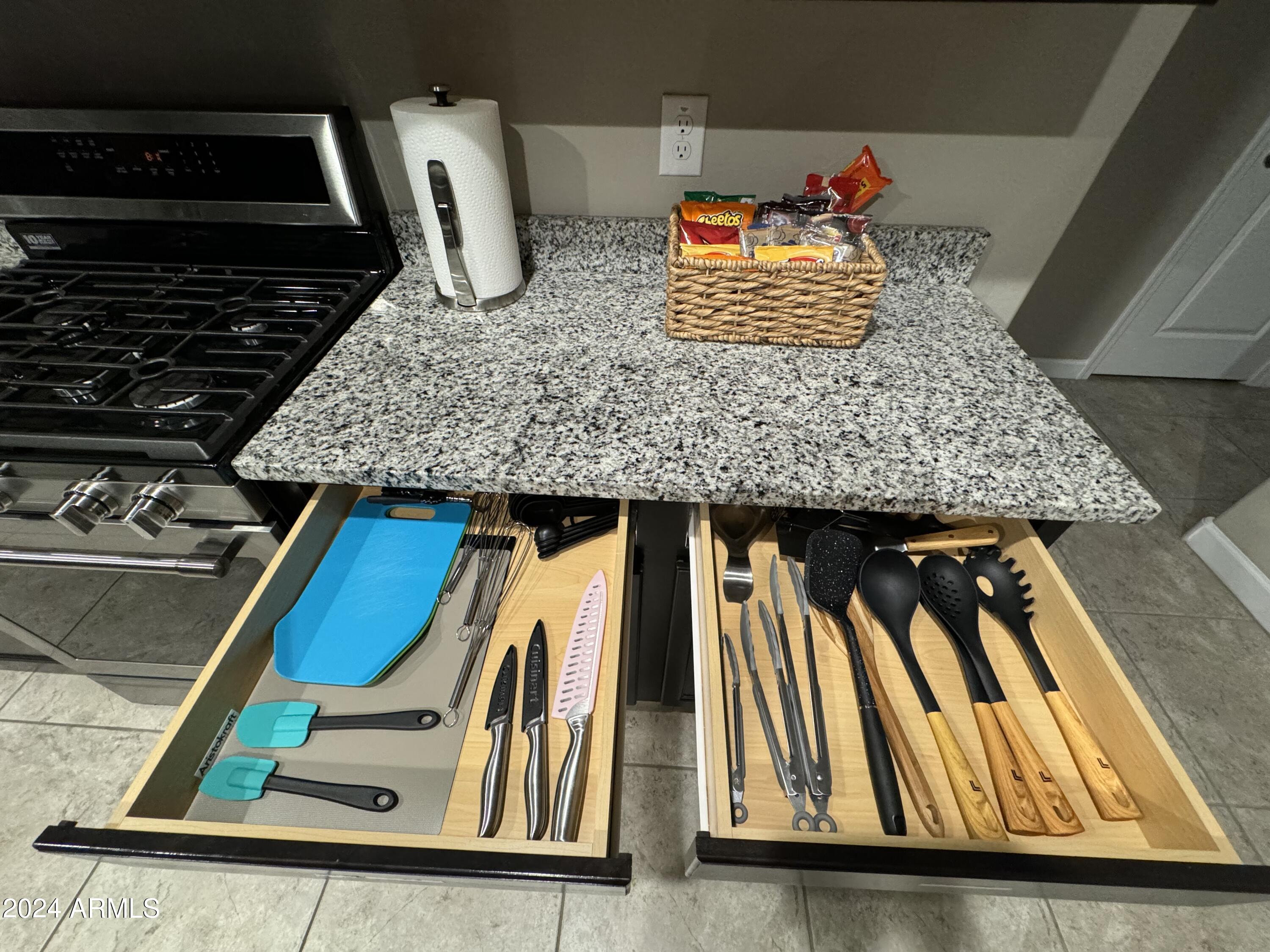 18735 North Ravello Road Maricopa, AZ 85138 - Photo 16 of 50 a kitchen with kitchen island granite countertop a sink and a stove