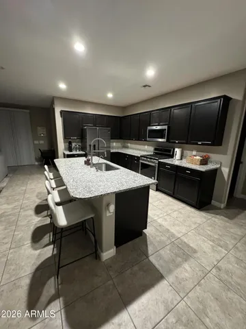 a kitchen with a table chairs refrigerator and microwave