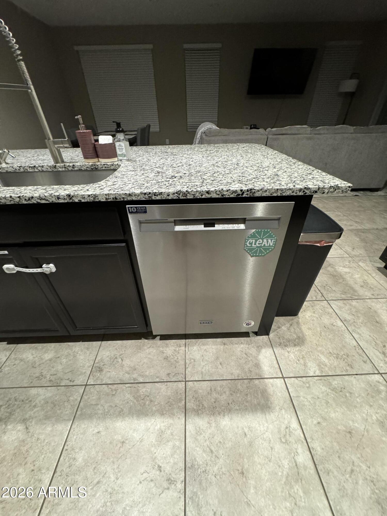 18735 North Ravello Road Maricopa, AZ 85138 - Photo 22 of 50 a kitchen with granite countertop a sink and a stove