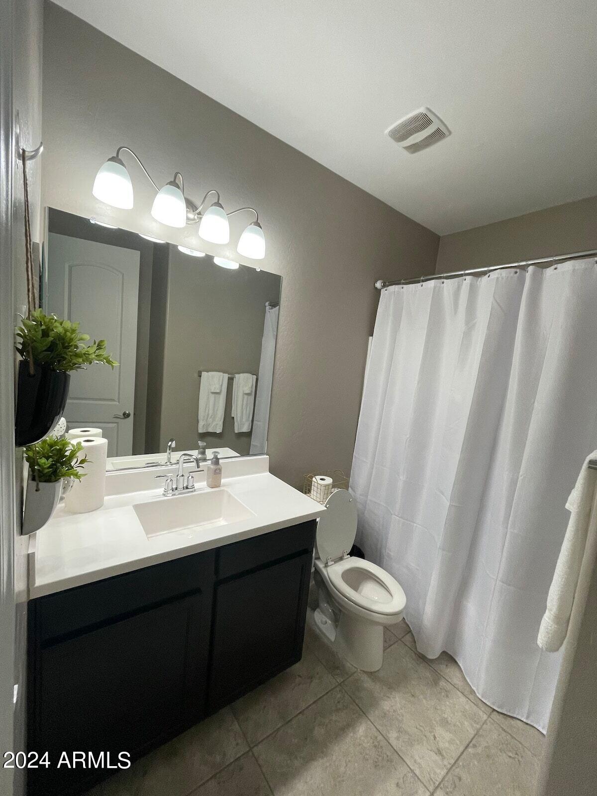 18735 North Ravello Road Maricopa, AZ 85138 - Photo 40 of 50 a bathroom with a double vanity sink toilet and a mirror