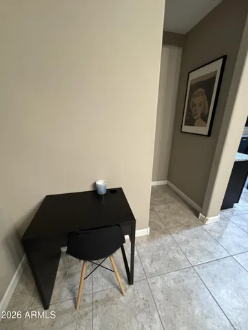 a black leather chair sitting in a empty room