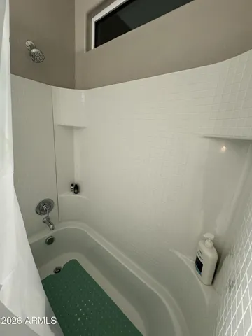 a bathroom with a tub and shower