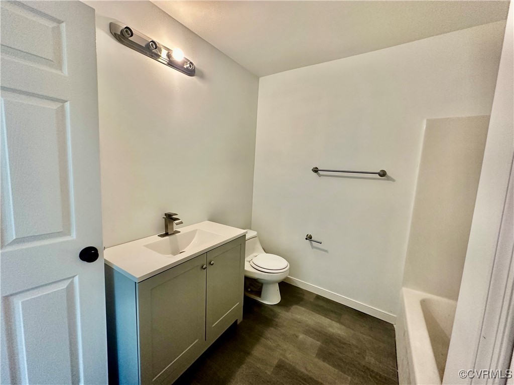 227 Horseshoe Road Jarratt, VA 23867 - Photo 11 of 14 a bathroom with a sink and mirror with toilet