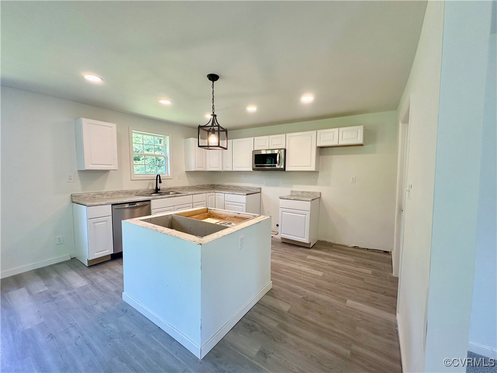 227 Horseshoe Road Jarratt, VA 23867 - Photo 6 of 14 a kitchen with a stove window and wooden floor