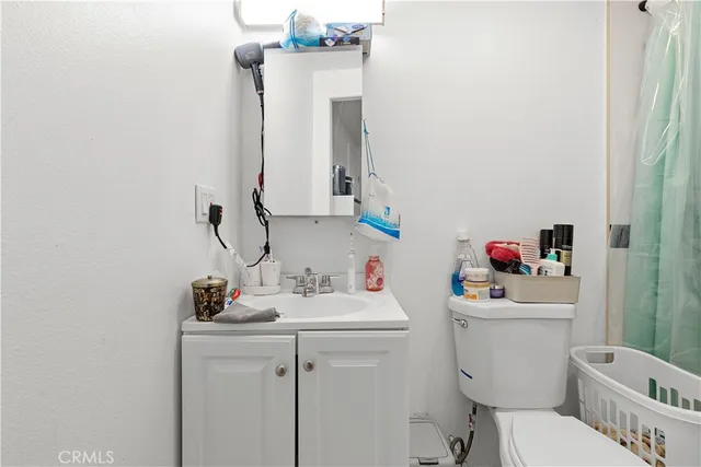 a bathroom with a sink toilet vanity and tub