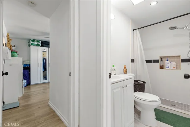 a bathroom with a toilet sink and a mirror