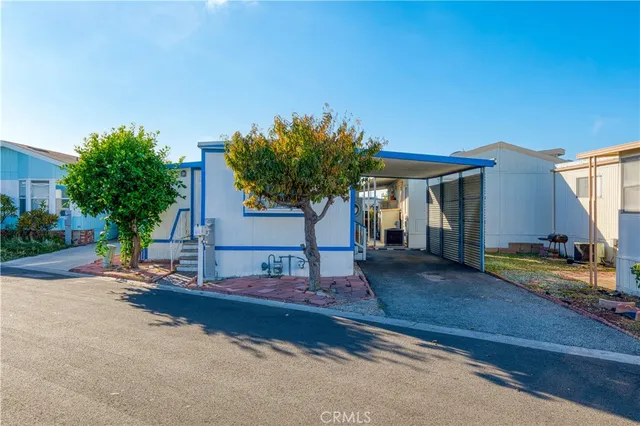 a view of a house with backyard and sitting area