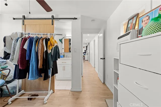 a view of walk in closet with clothes and shoes