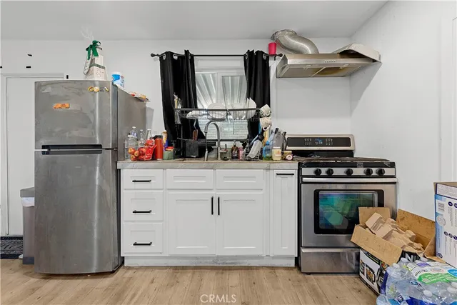a kitchen with stainless steel appliances a stove and cabinets