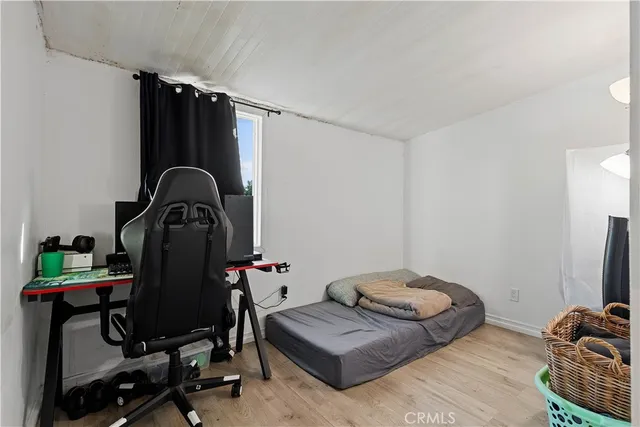a bedroom with furniture and a gym equipment