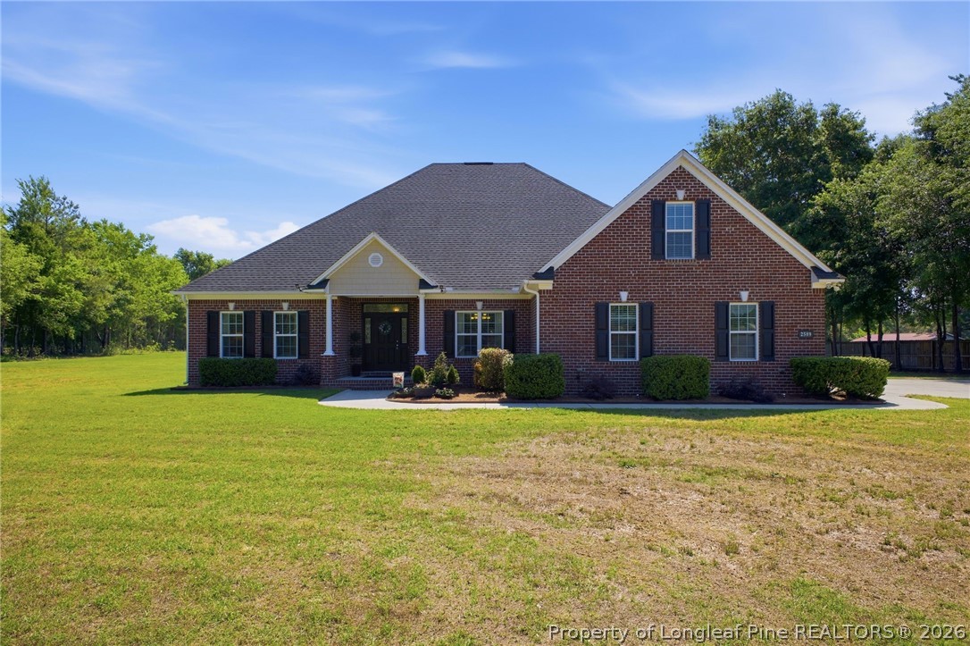2589 June Johnson Road Raeford, NC 28376 - Photo 2 of 49 a front view of a house with yard porch and green space