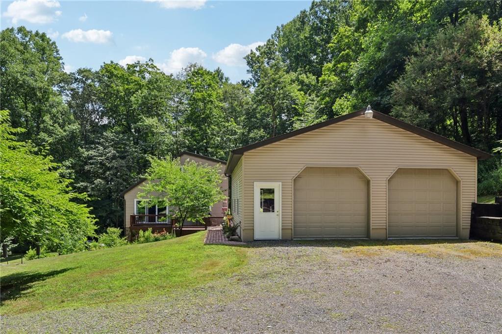 447 Creek Road Fredonia, PA 16124 - Photo 32 of 44 a view of a house with a yard and garage