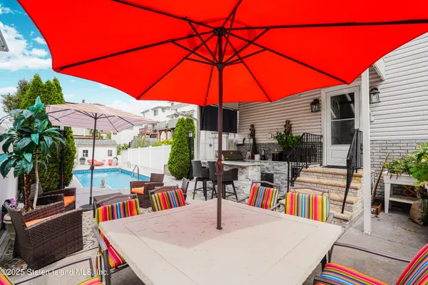 a view of outdoor kitchen with seating space