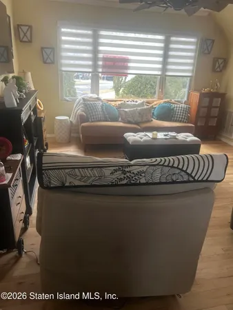 a bedroom with furniture and a wooden floor