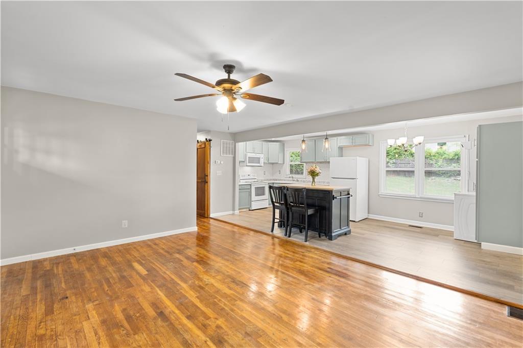 2161 Rochelle Way Southwest Atlanta, GA 30349 - Photo 1 of 15 an empty room with fireplace and chandelier fan