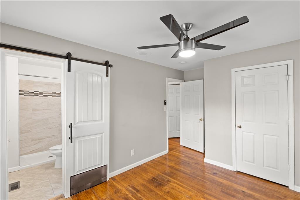 2161 Rochelle Way Southwest Atlanta, GA 30349 - Photo 10 of 15 a view of a livingroom with a ceiling fan and wooden floor