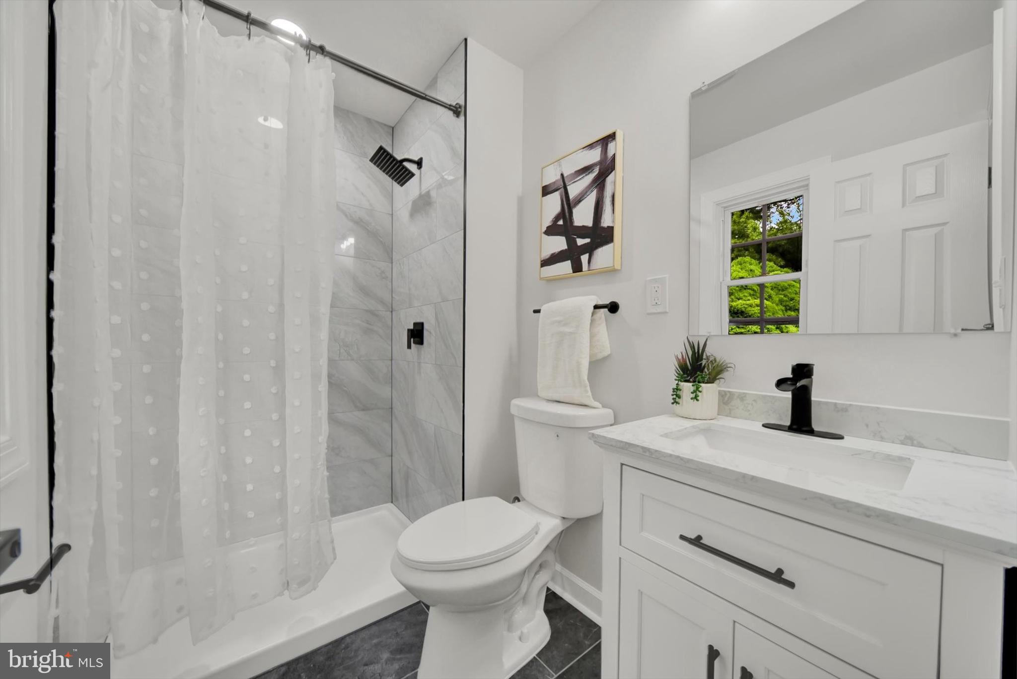3808 Perryhurst Place Baltimore, MD 21236 - Photo 17 of 29 a bathroom with a sink a toilet and shower