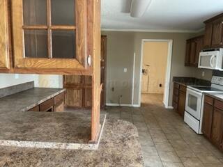 323 County Road 305 Panhandle, TX 79068 - Photo 12 of 23 a view of a kitchen with microwave and cabinets