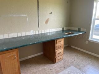 323 County Road 305 Panhandle, TX 79068 - Photo 18 of 23 a kitchen with a sink and a wooden floor