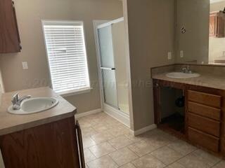 323 County Road 305 Panhandle, TX 79068 - Photo 22 of 23 a bathroom with a sink and a mirror
