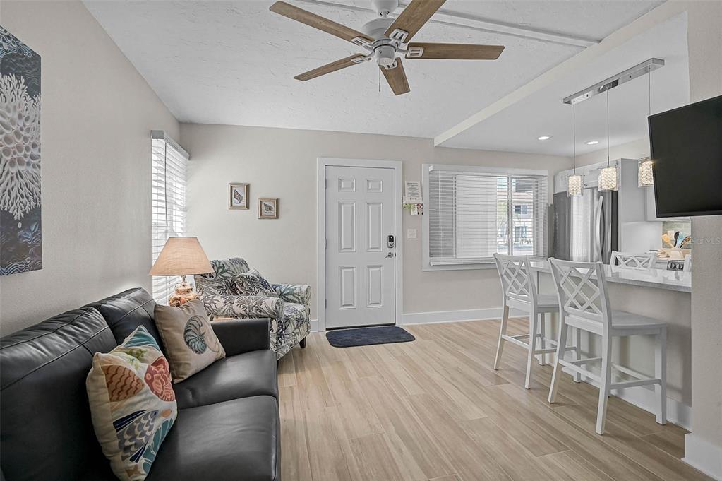 5950 Midnight Pass Road, Unit 101 Sarasota, FL 34242 - Photo 12 of 17 a living room with furniture and a wooden floor