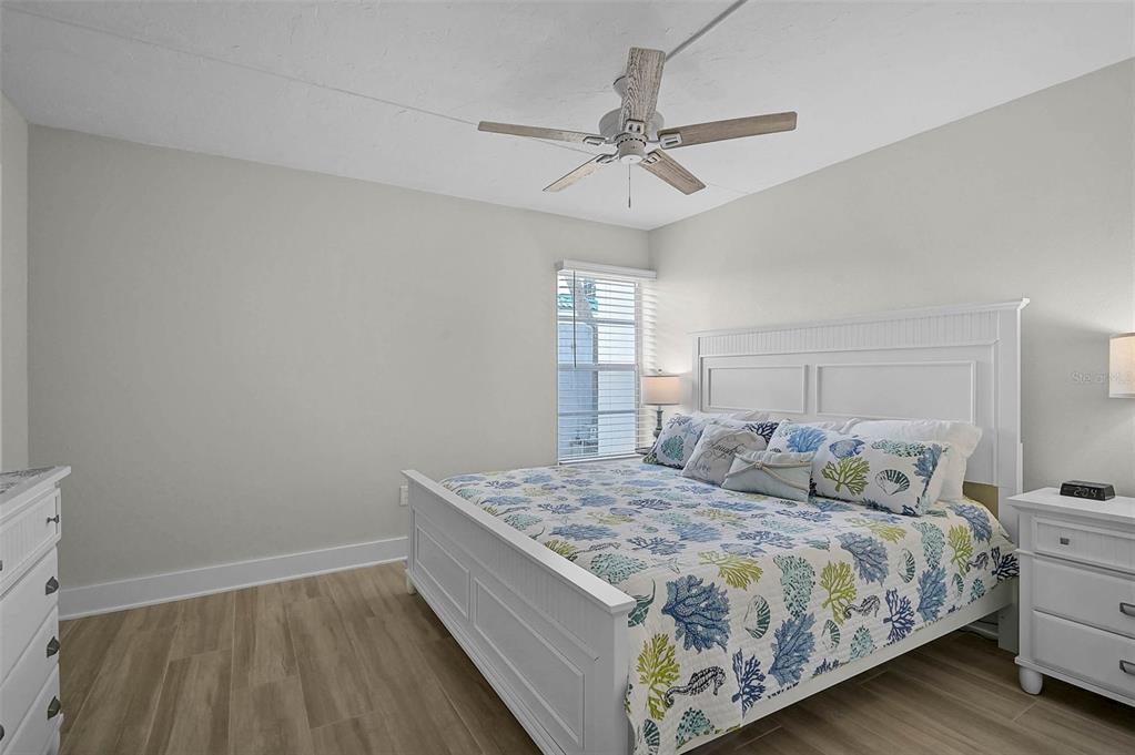 5950 Midnight Pass Road, Unit 101 Sarasota, FL 34242 - Photo 14 of 17 a bedroom with a bed and window