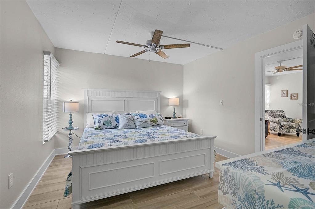 5950 Midnight Pass Road, Unit 101 Sarasota, FL 34242 - Photo 15 of 17 a en suite bathroom with a granite countertop sink and a mirror