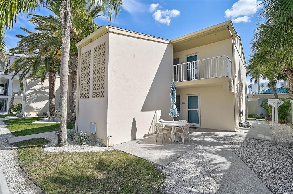 5950 Midnight Pass Road, Unit 101 Sarasota, FL 34242 - Photo 3 of 17 a view of a house with a patio