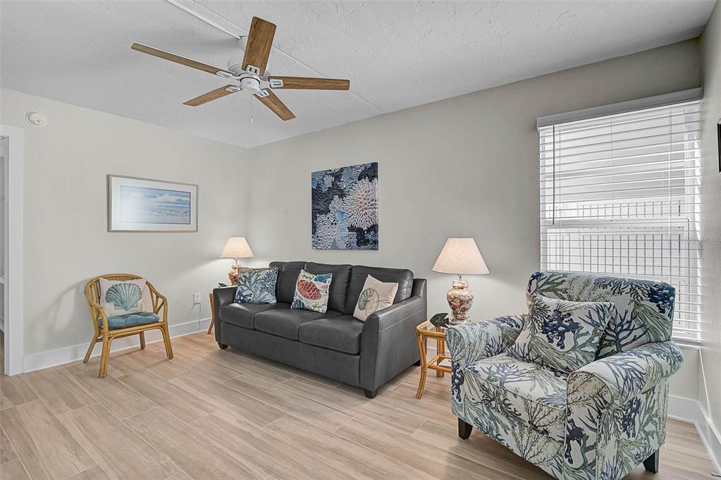 5950 Midnight Pass Road, Unit 101 Sarasota, FL 34242 - Photo 10 of 17 a living room with furniture and a window