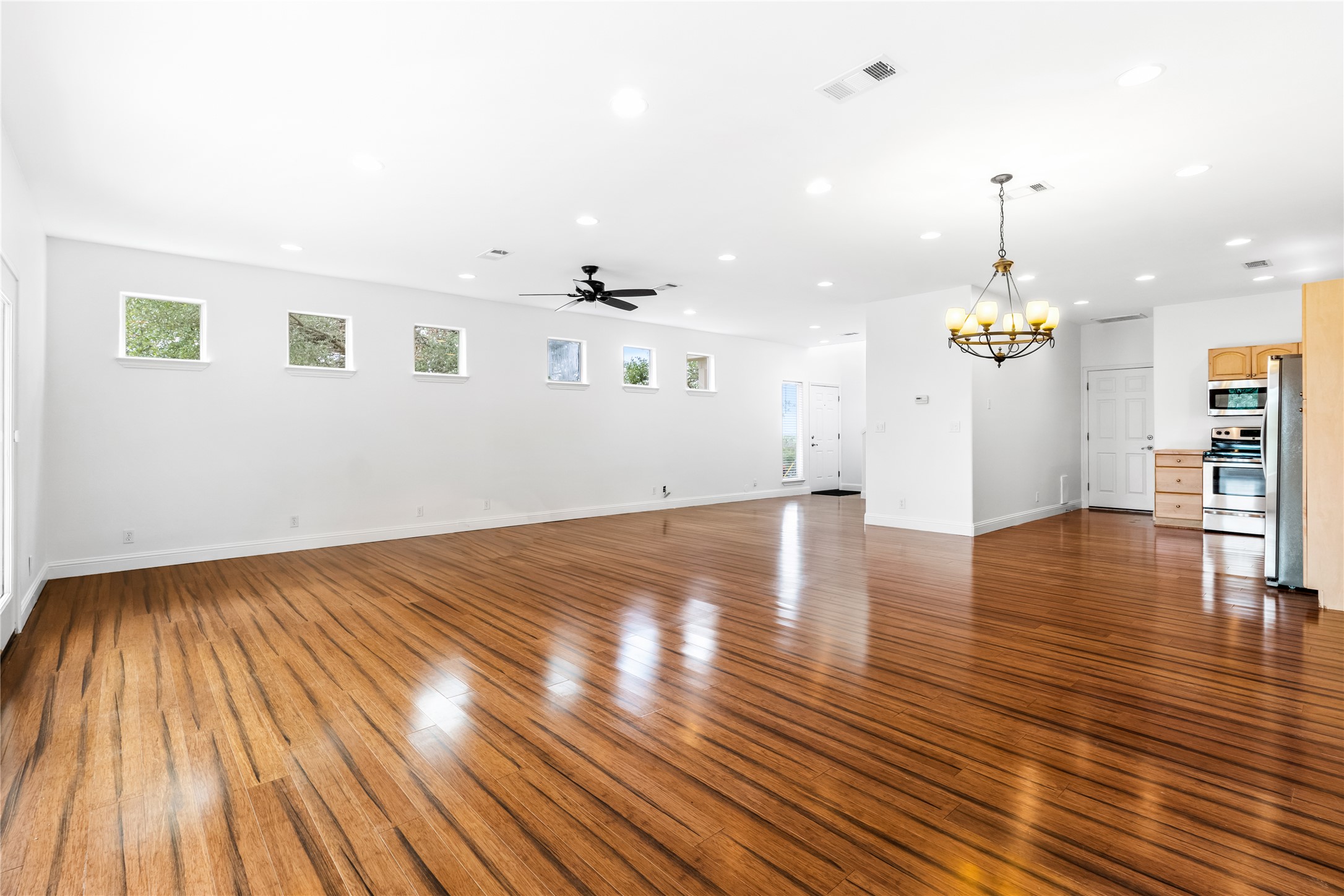 5500 Sunset Ridge, Unit A & B Austin, TX 78735 - Photo 21 of 32 a view of empty room with wooden floor and kitchen view