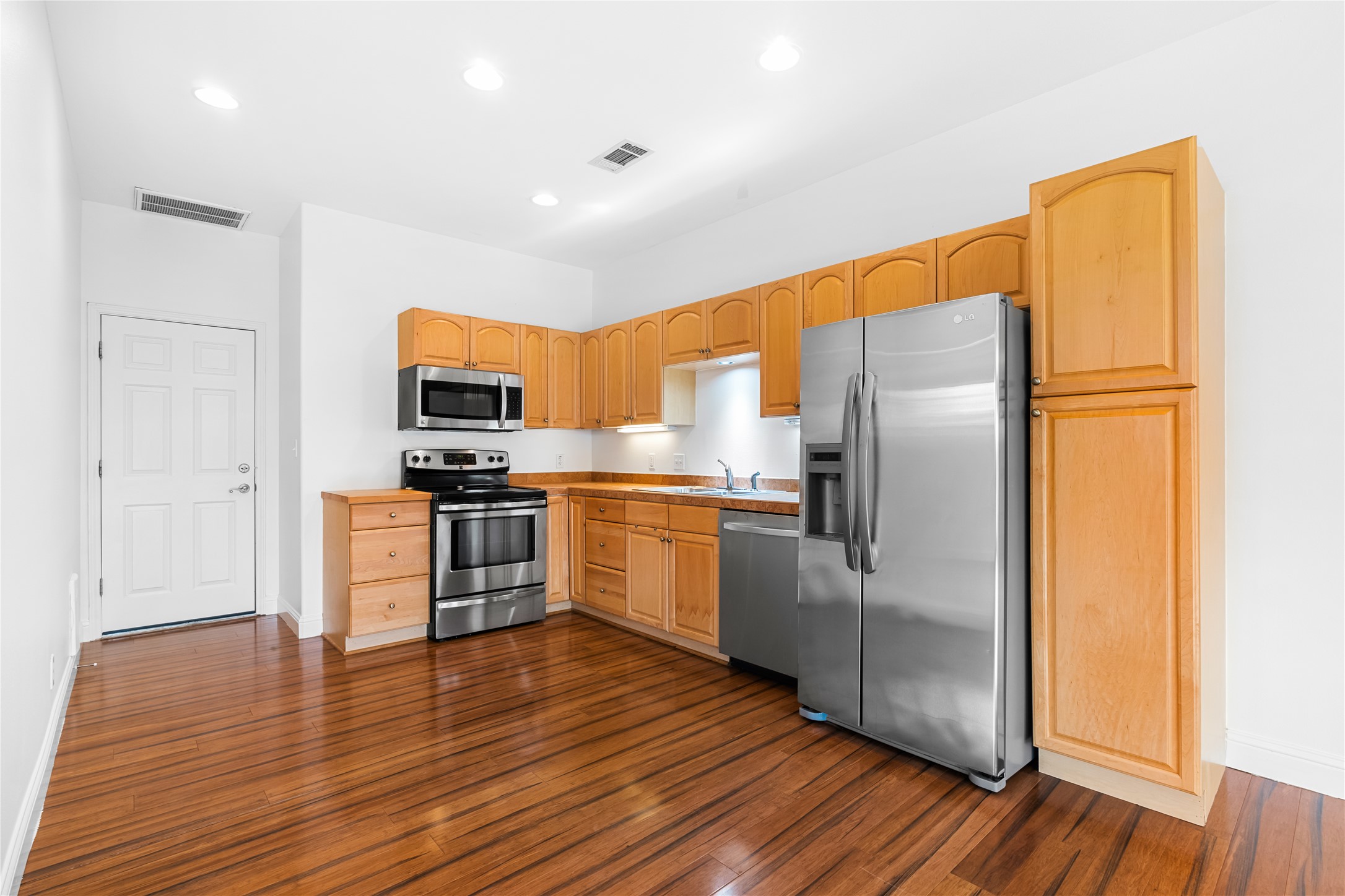 5500 Sunset Ridge, Unit A & B Austin, TX 78735 - Photo 25 of 32 a kitchen with stainless steel appliances a refrigerator and a stove top oven