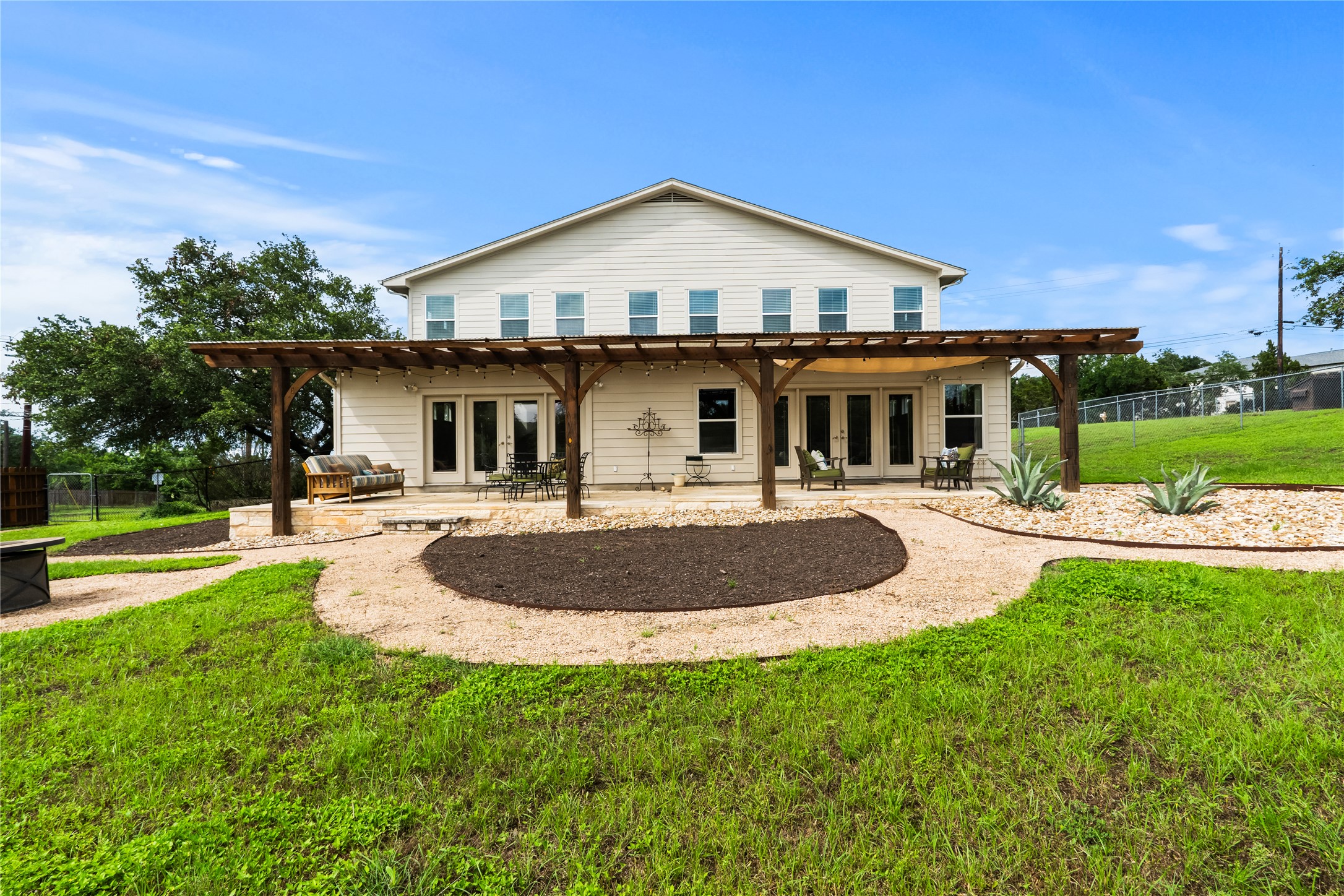 5500 Sunset Ridge, Unit A & B Austin, TX 78735 - Photo 7 of 32 a front view of a house with a yard table and chairs