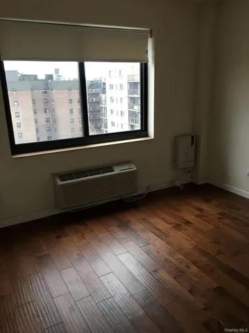 a view of a room with wooden floor and windows