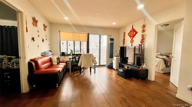 a living room with furniture flat screen tv and a large window